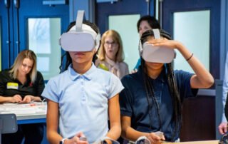 Verizon STEM lab kids in blue shirts with VR headset